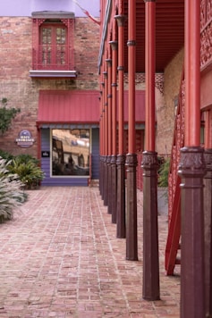 a red building with a clock on the front of it