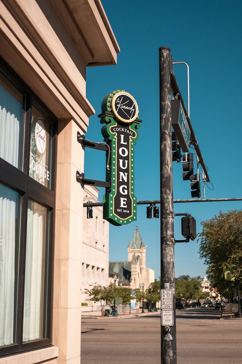 a clock on the side of a building next to a street