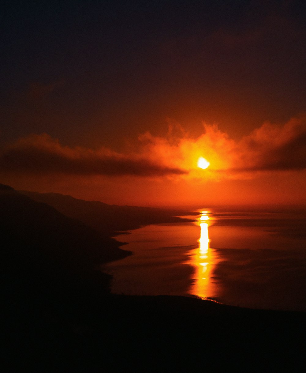 the sun is setting over a body of water