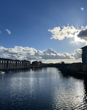 a body of water with buildings in the background