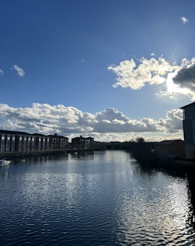 a body of water with buildings in the background