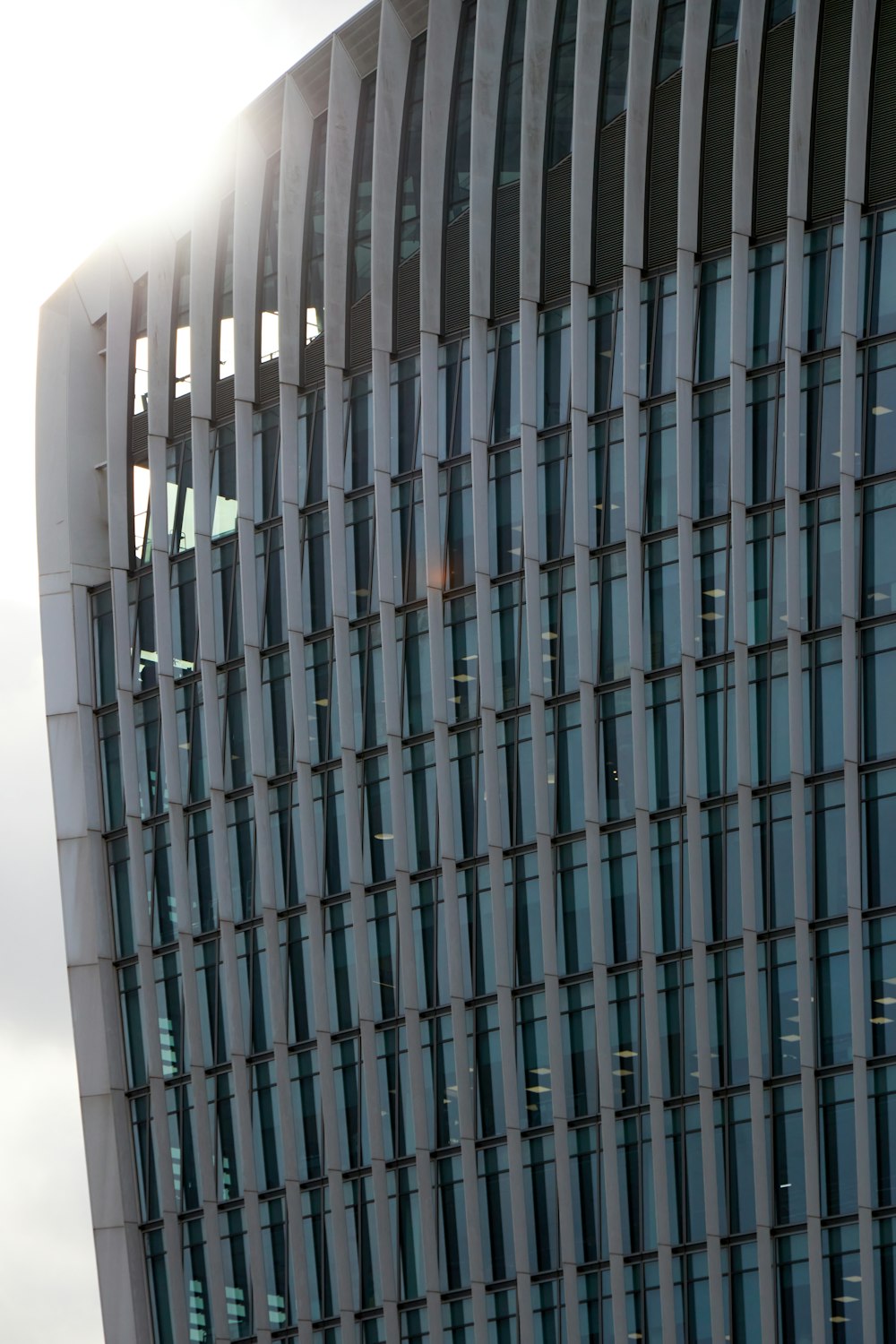 a tall building with many windows and a sky background