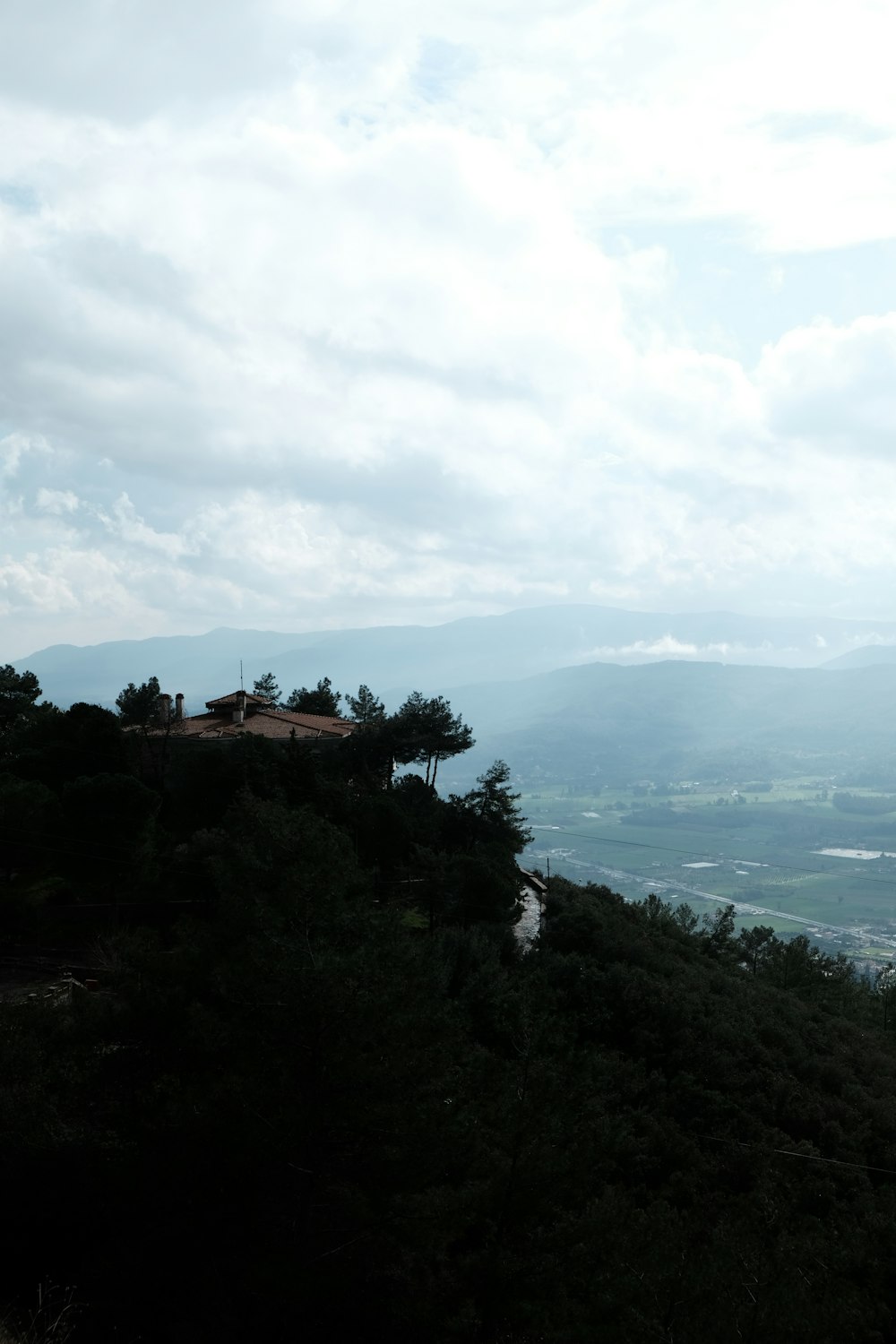 a view of a hill with a house on top of it