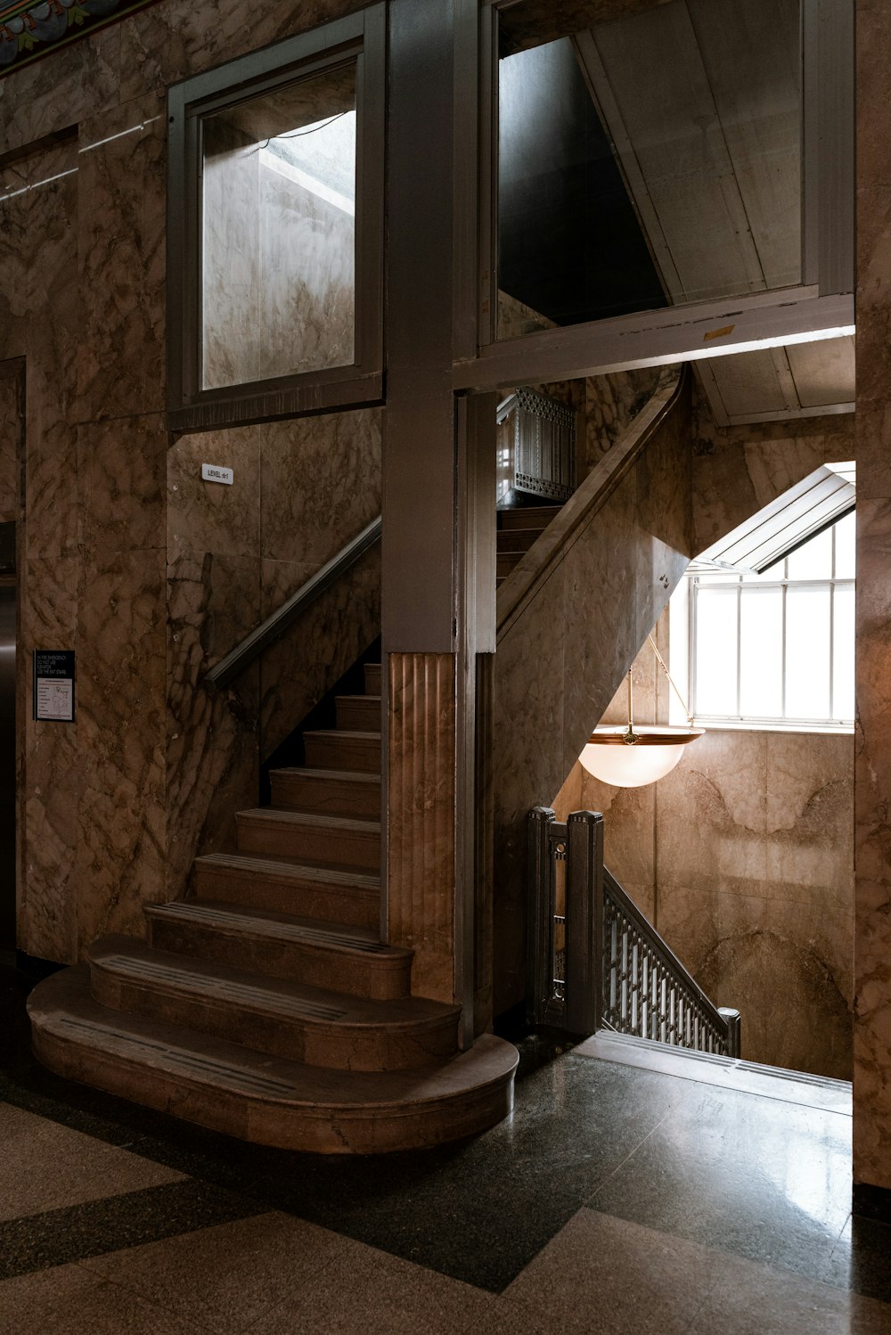 a staircase in a building with marble walls