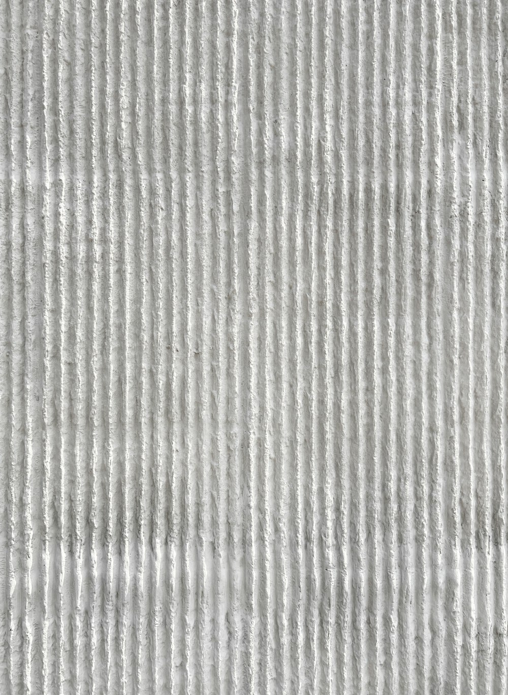 a close up of a white textured wallpaper