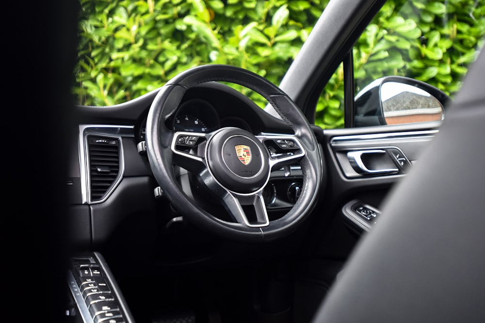 the interior of a car with a steering wheel and dashboard