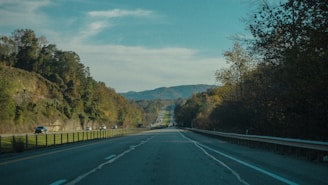 A modern highway connecting Haridwar to Delhi, surrounded by lush greenery.