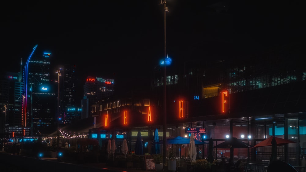 a city street at night with buildings lit up