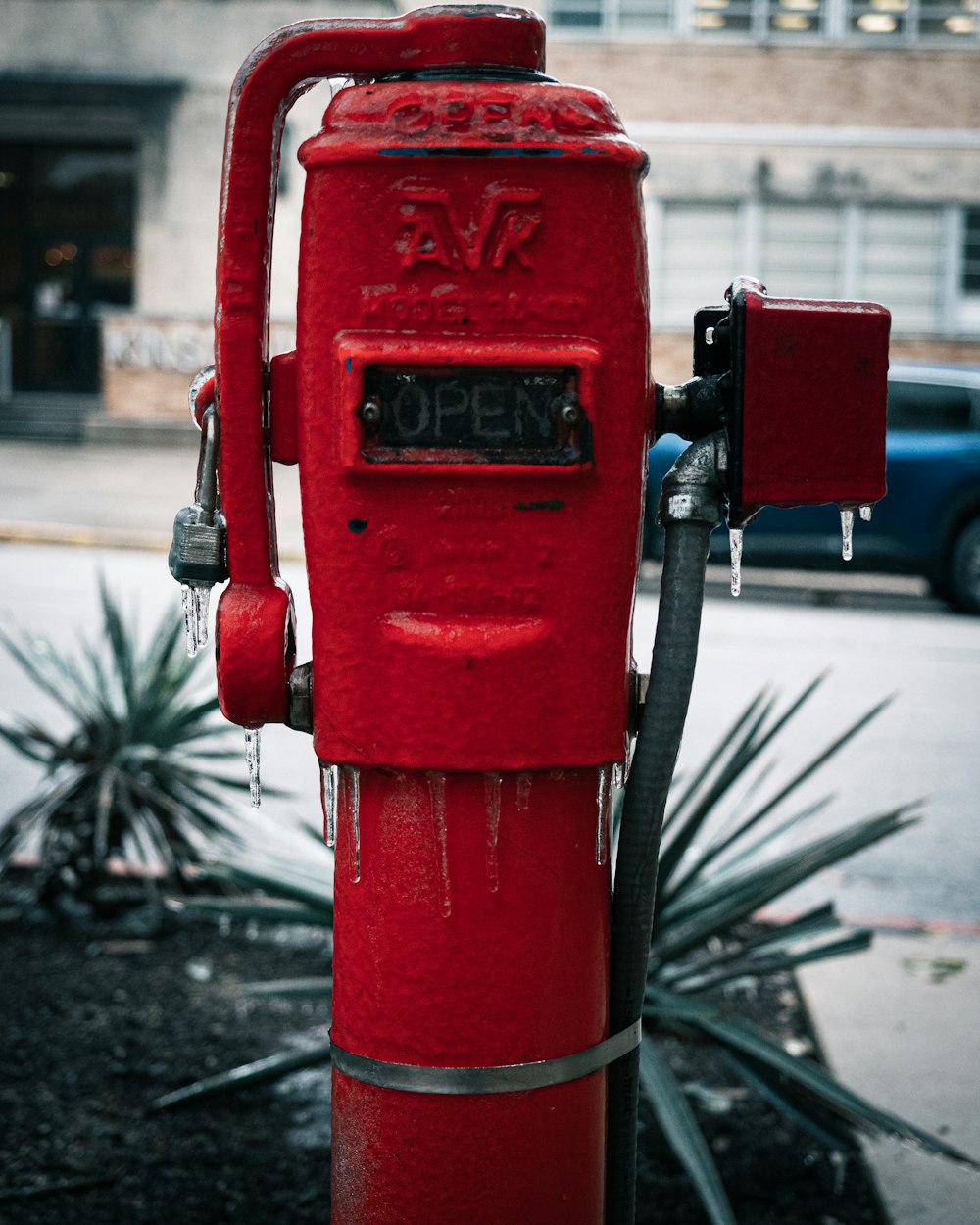 a red fire hydrant sitting on the side of a road