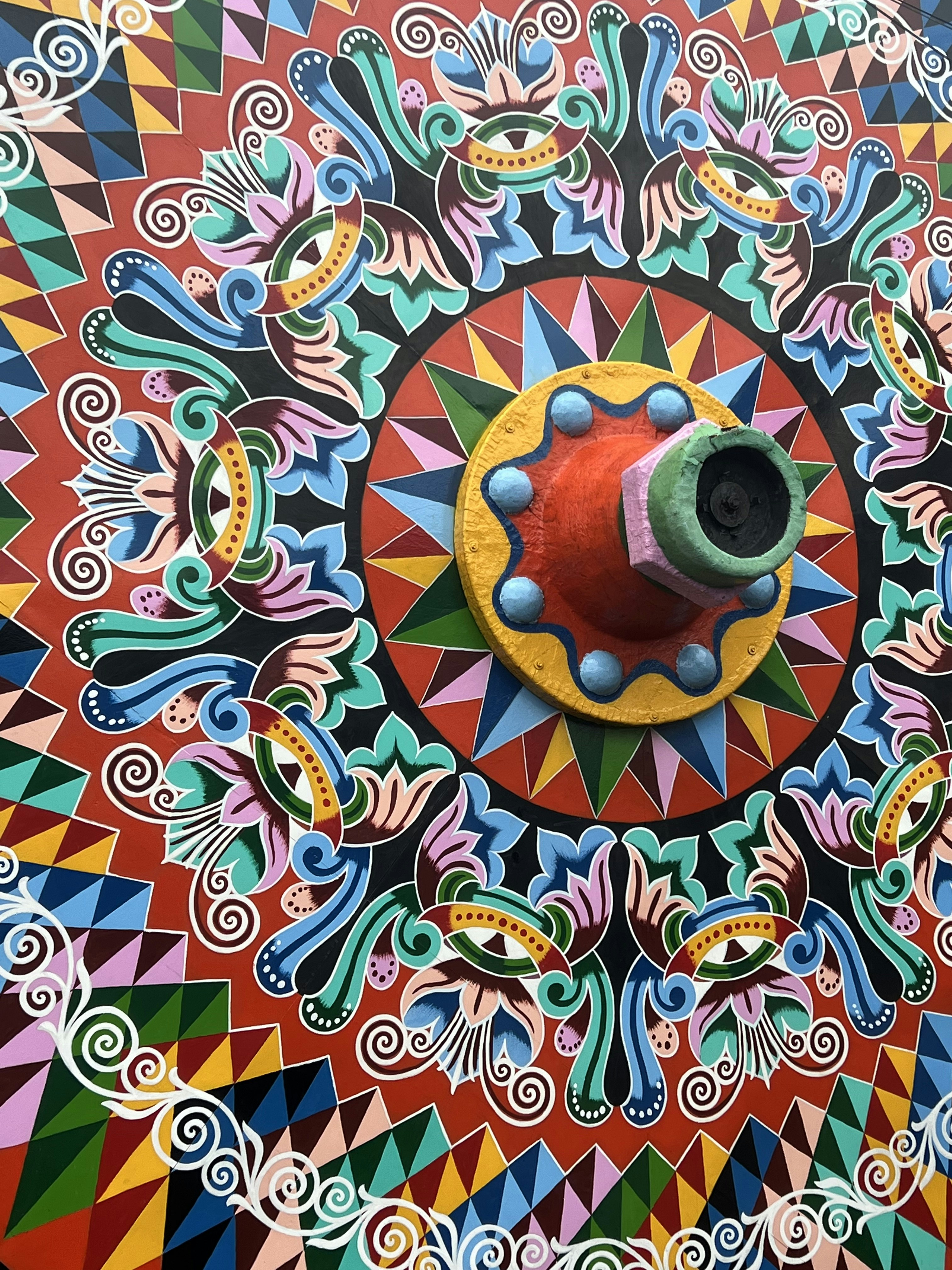Colorful traditional folk art patterns with intricate geometric designs and natural motifs, bright vibrant artistic environment