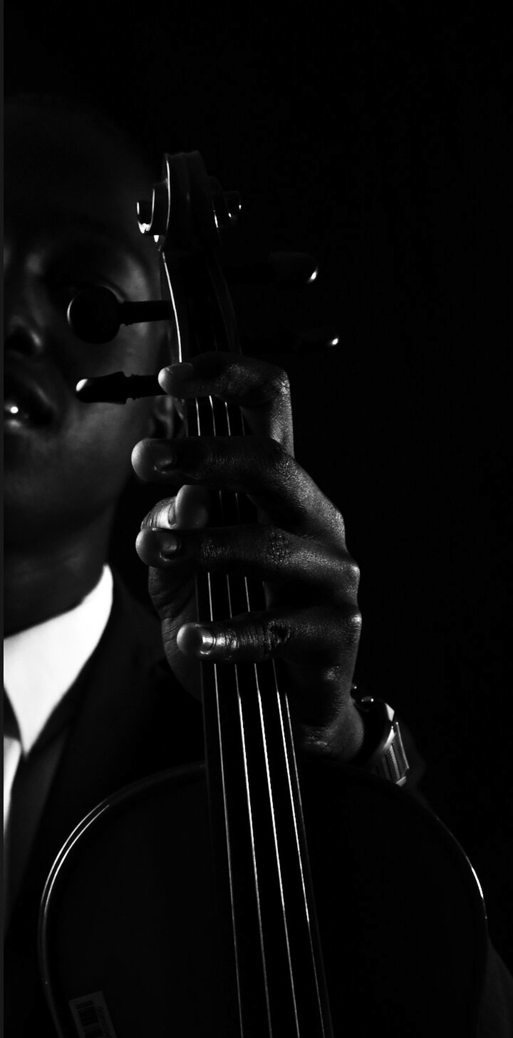 a black and white photo of a man holding a guitar