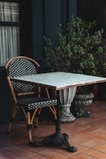 a table and two chairs sitting on a patio