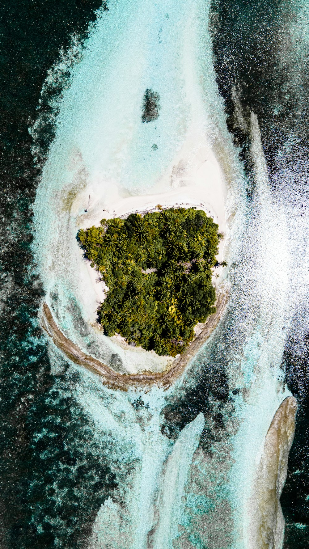 an aerial view of an island in the middle of the ocean