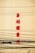 Red Chinese characters are displayed vertically on a yellow wall, with numerous black electrical cables crossing in front.