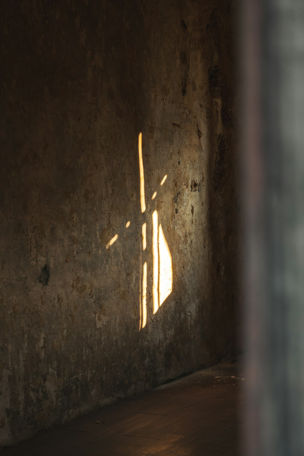 a shadow of a cross on a wall