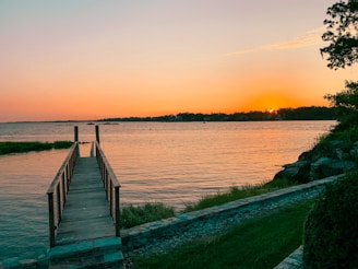 A serene view of a freshly installed wooden dock at Lac-Etchemin during sunset.