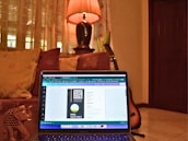 A creative educator designing a digital course on a laptop in a cozy home office.