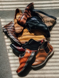 a pile of shoes sitting on top of a carpet