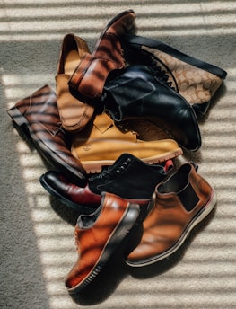 a pile of shoes sitting on top of a carpet