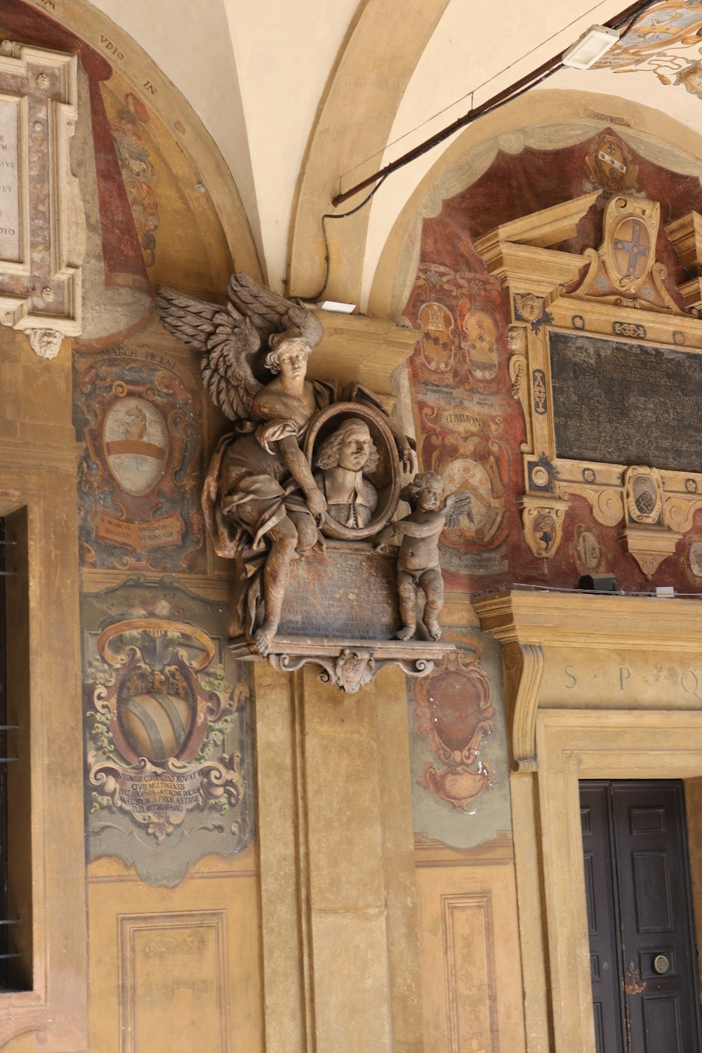 a statue of an angel on top of a shelf