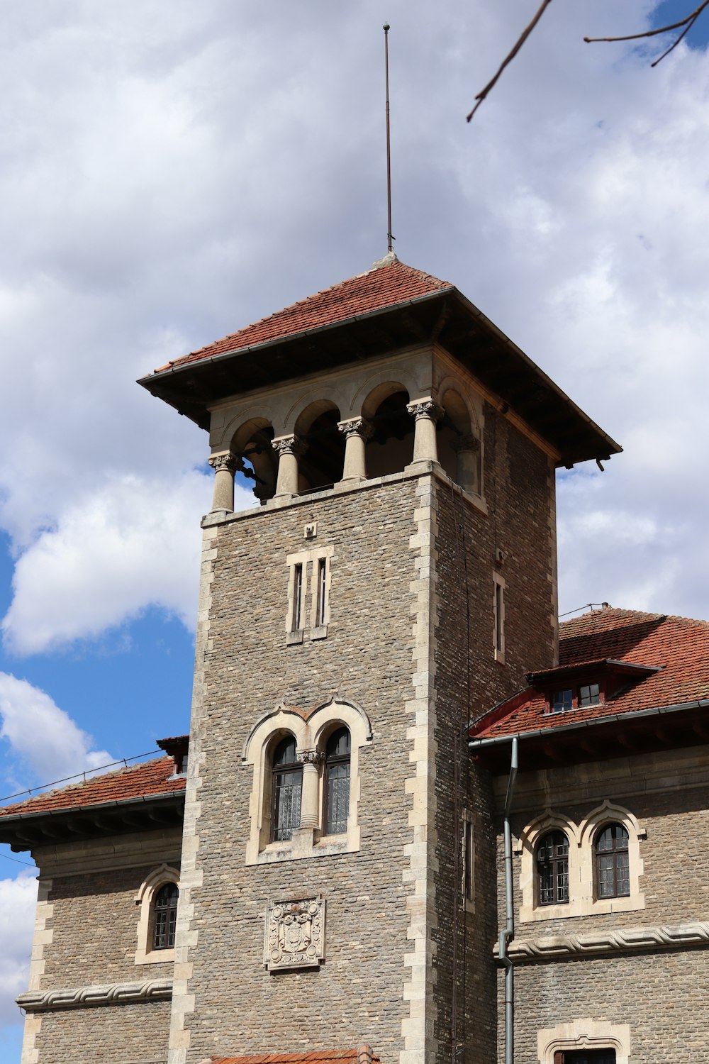 a tall brick building with a clock on it's side