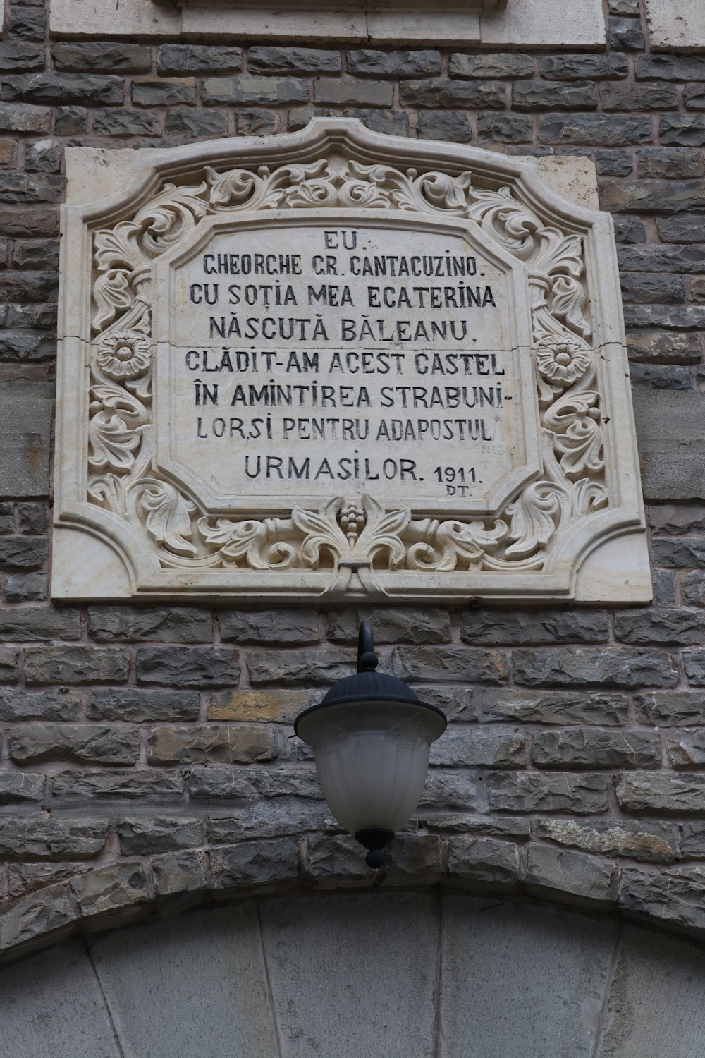 a sign on the side of a brick building