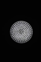 A circular light source composed of multiple small, bright LED bulbs, arranged densely in a grid pattern against a black background. The LEDs emit a cool white glow, creating a striking contrast.