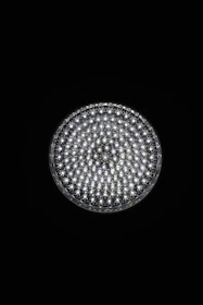 A circular light source composed of multiple small, bright LED bulbs, arranged densely in a grid pattern against a black background. The LEDs emit a cool white glow, creating a striking contrast.