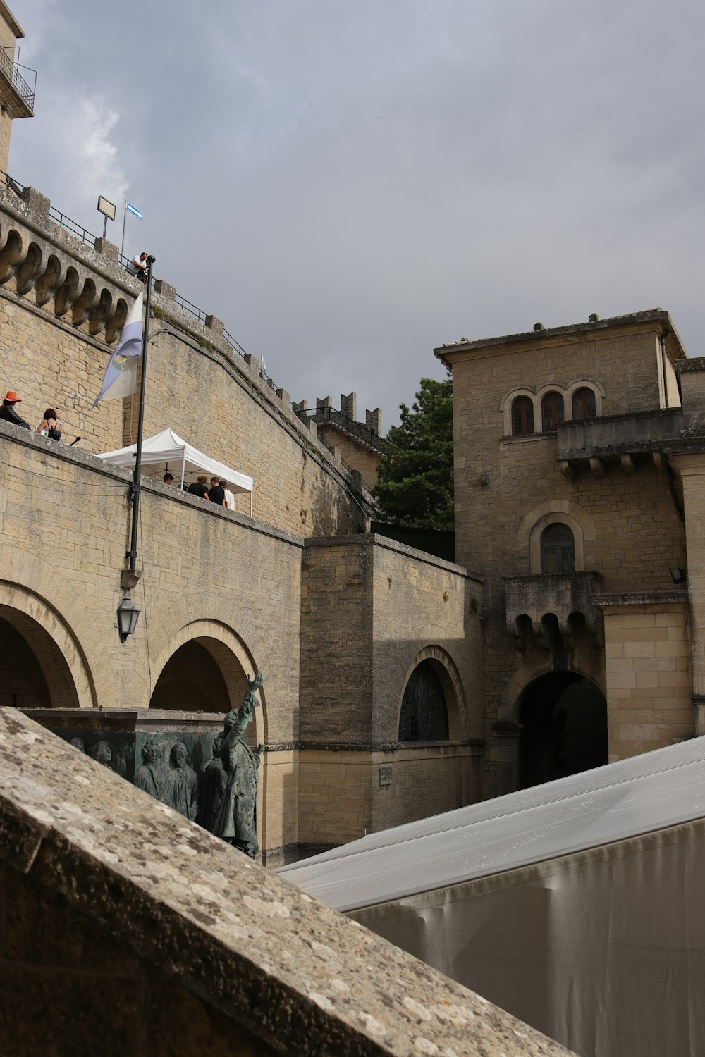 a stone building with a clock tower in the background