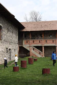 An archival image showing the original Enon Valley schoolhouse surrounded by children playing in the yard.