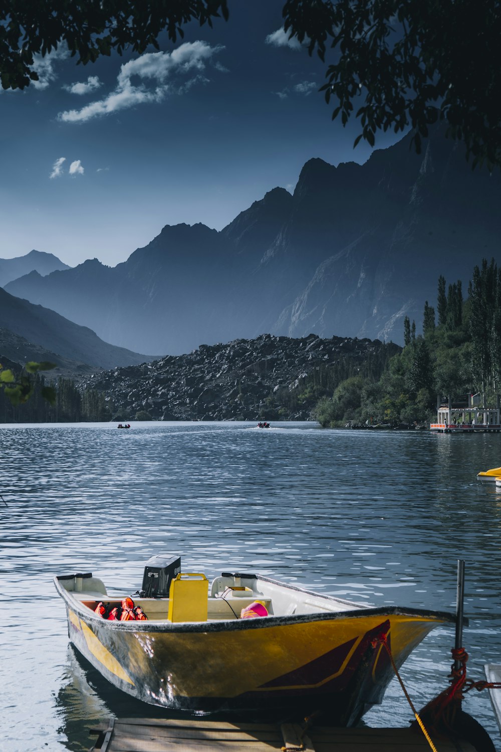 a small yellow boat sitting on top of a body of water