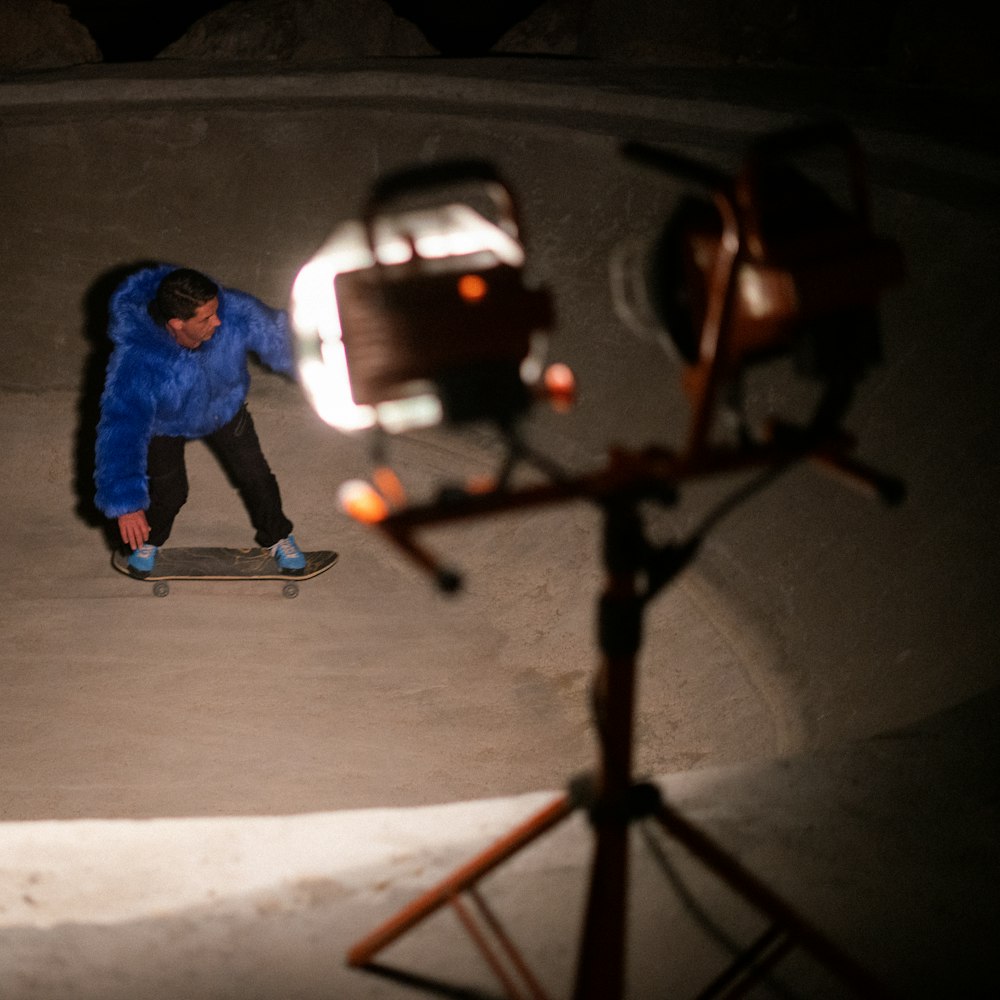 a man riding a skateboard next to a camera