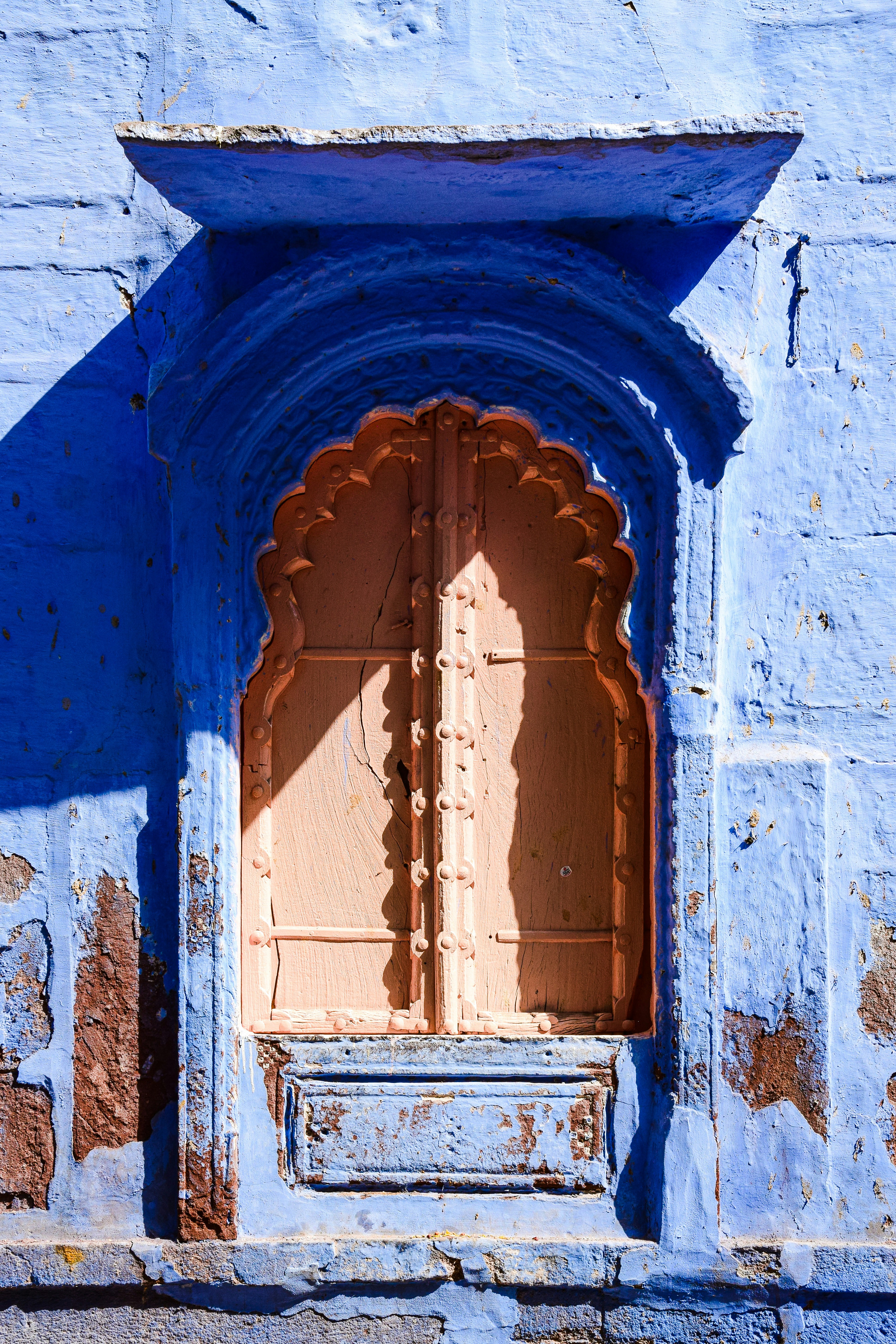 A blue building with a wooden door and window photo – Free Jodhpur ...