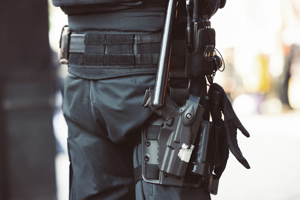 a man holding a gun and a gun holster