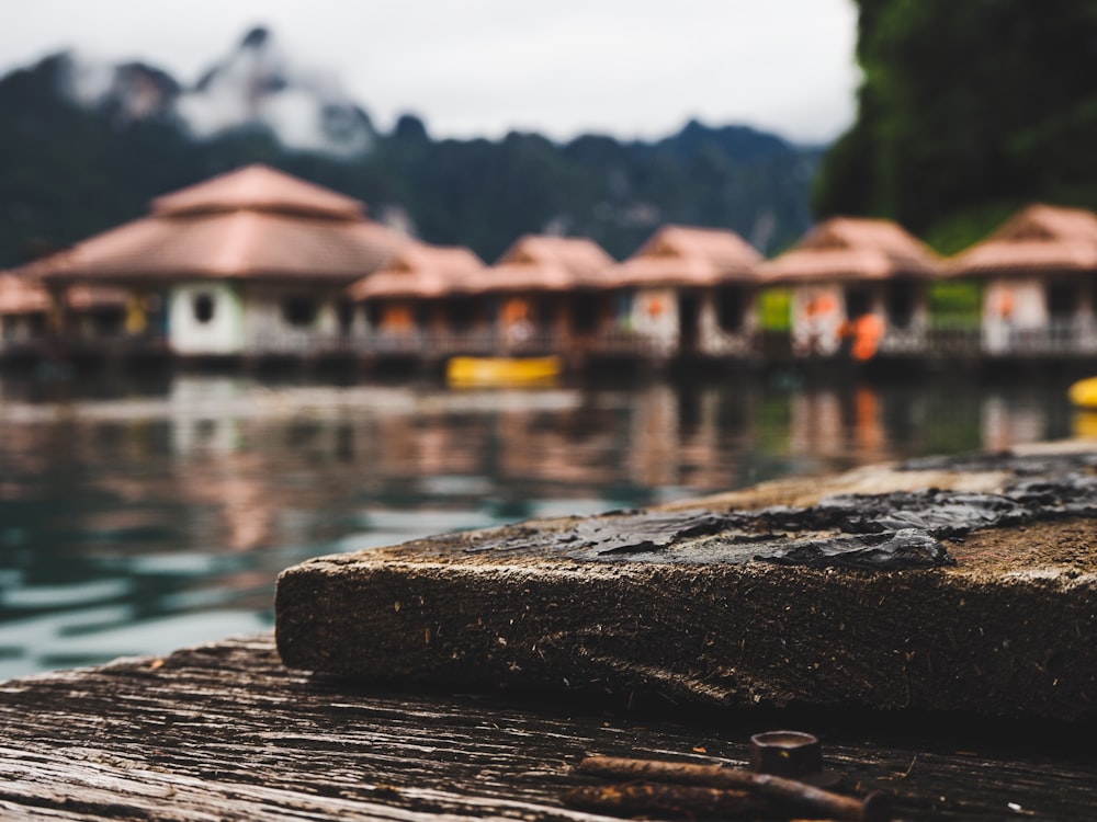 a view of a body of water with houses in the background