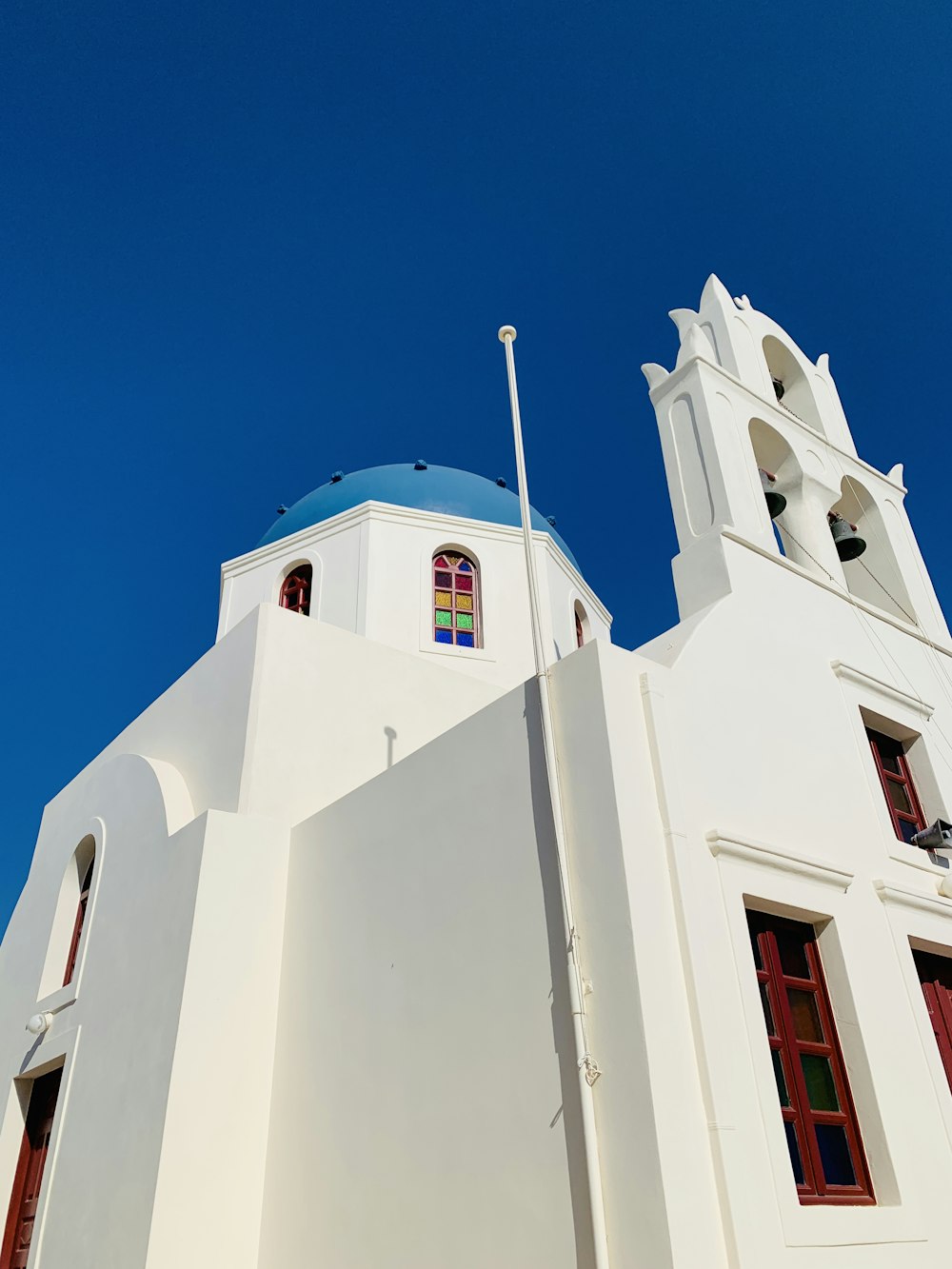 a tall white building with a blue roof