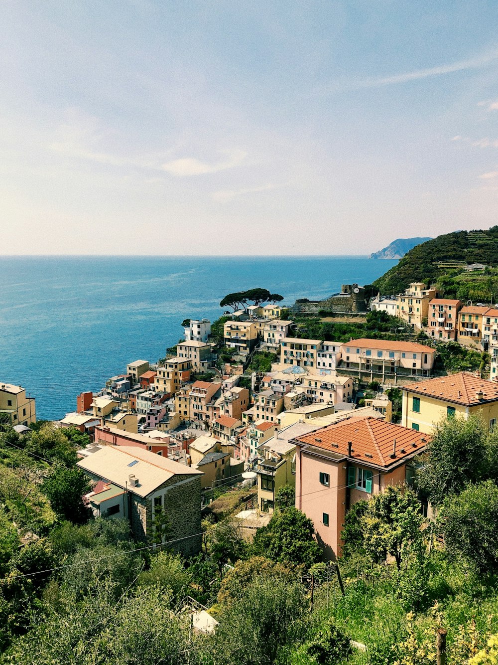 a view of a town on a hill overlooking the ocean