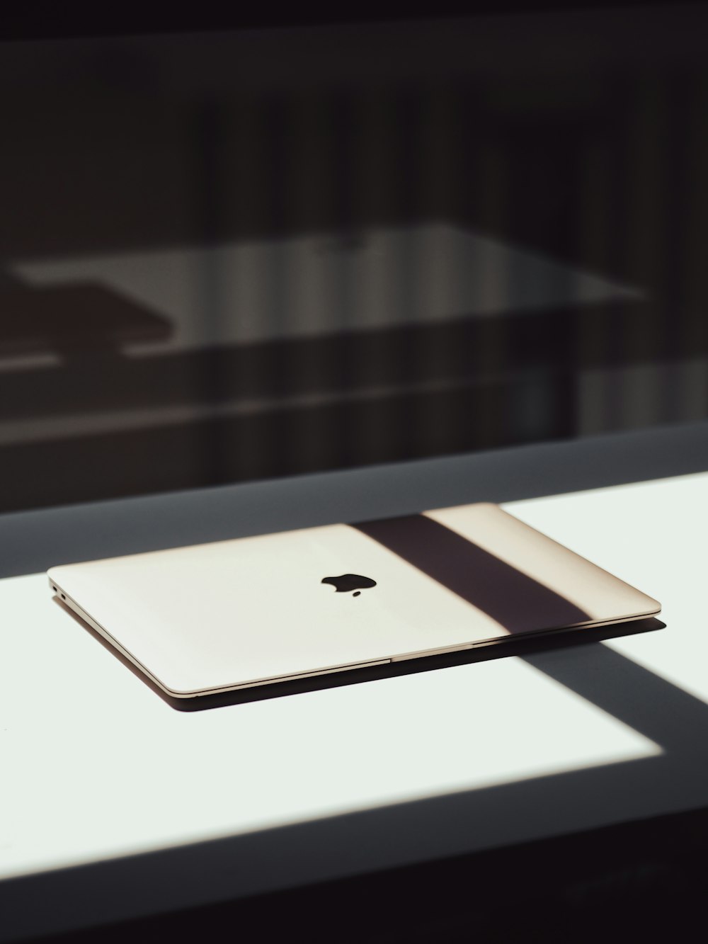 a laptop computer sitting on top of a white table