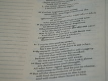 A close-up view of a page from a Bible, featuring passages in both regular and bold text. The text is formatted in a column with numbers preceding certain lines, set against a background of light-colored paper.