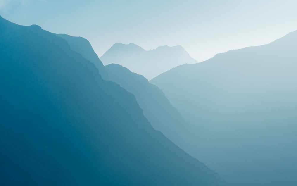 a view of a mountain range in the fog