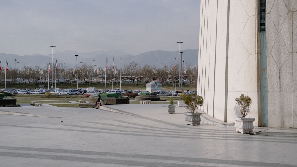 a man riding a skateboard down a sidewalk next to a tall building