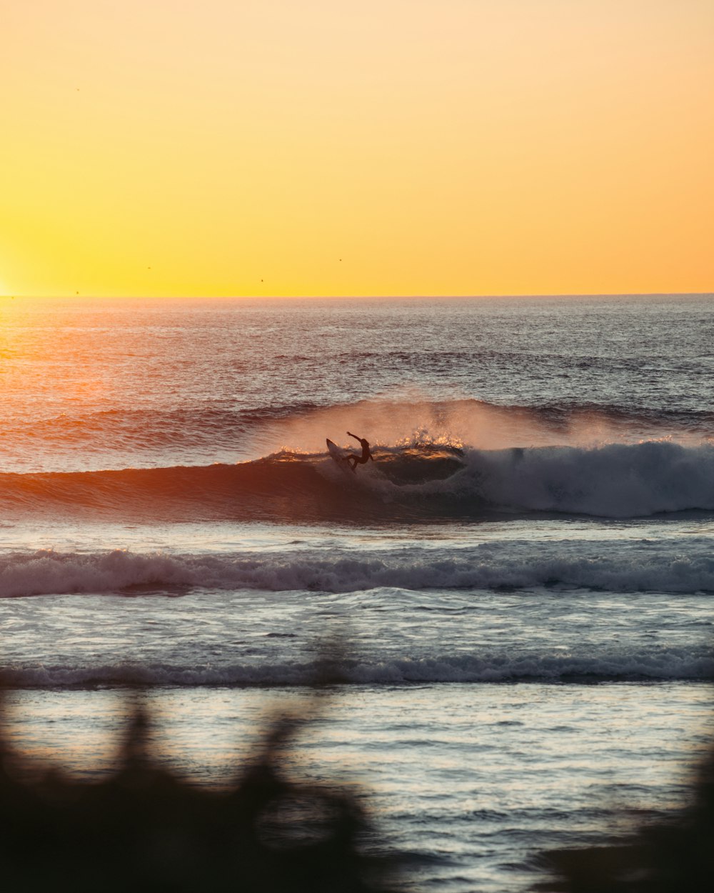 a person riding a surfboard on a wave in the ocean