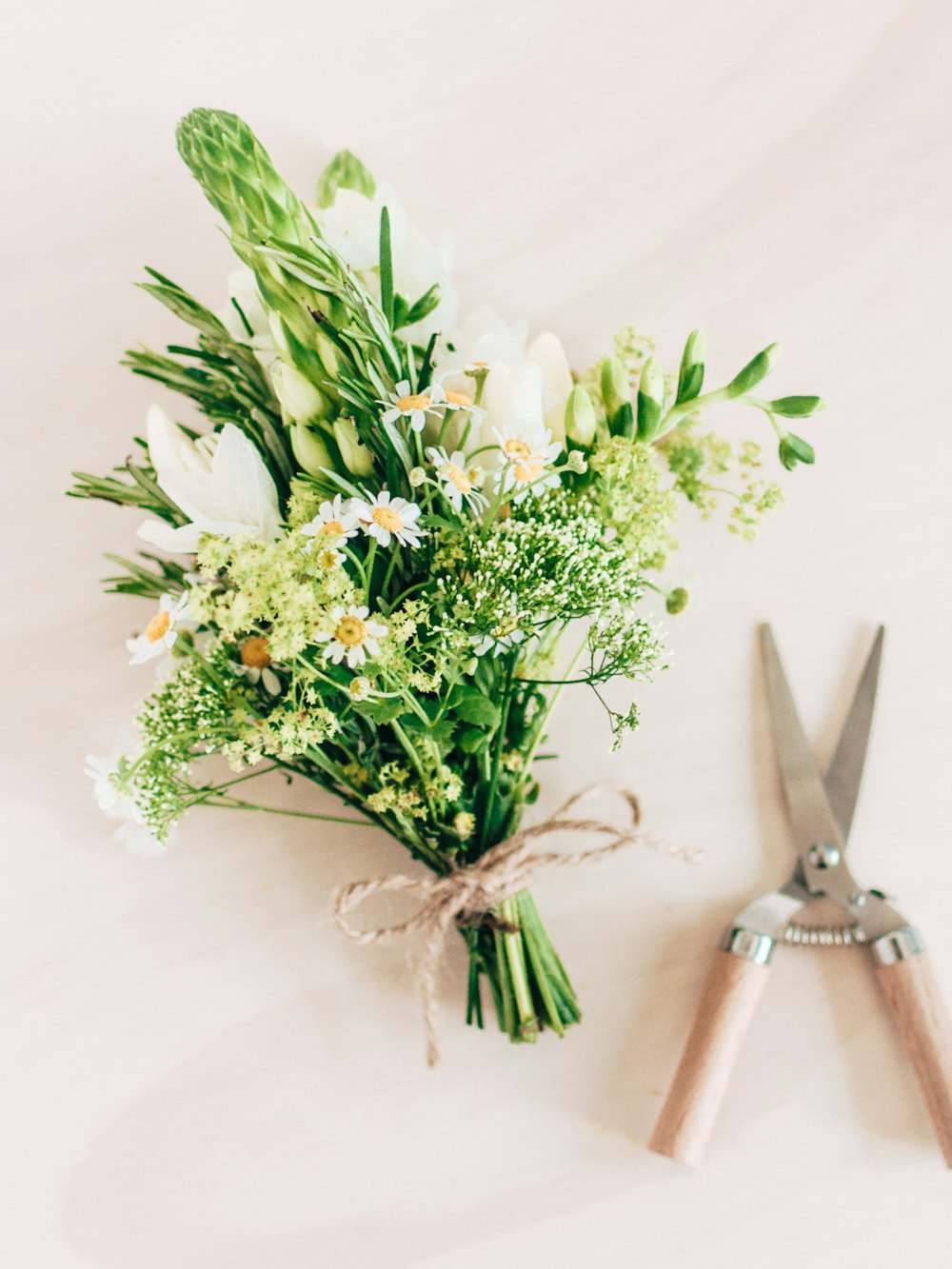 a bouquet of flowers sitting next to a pair of scissors
