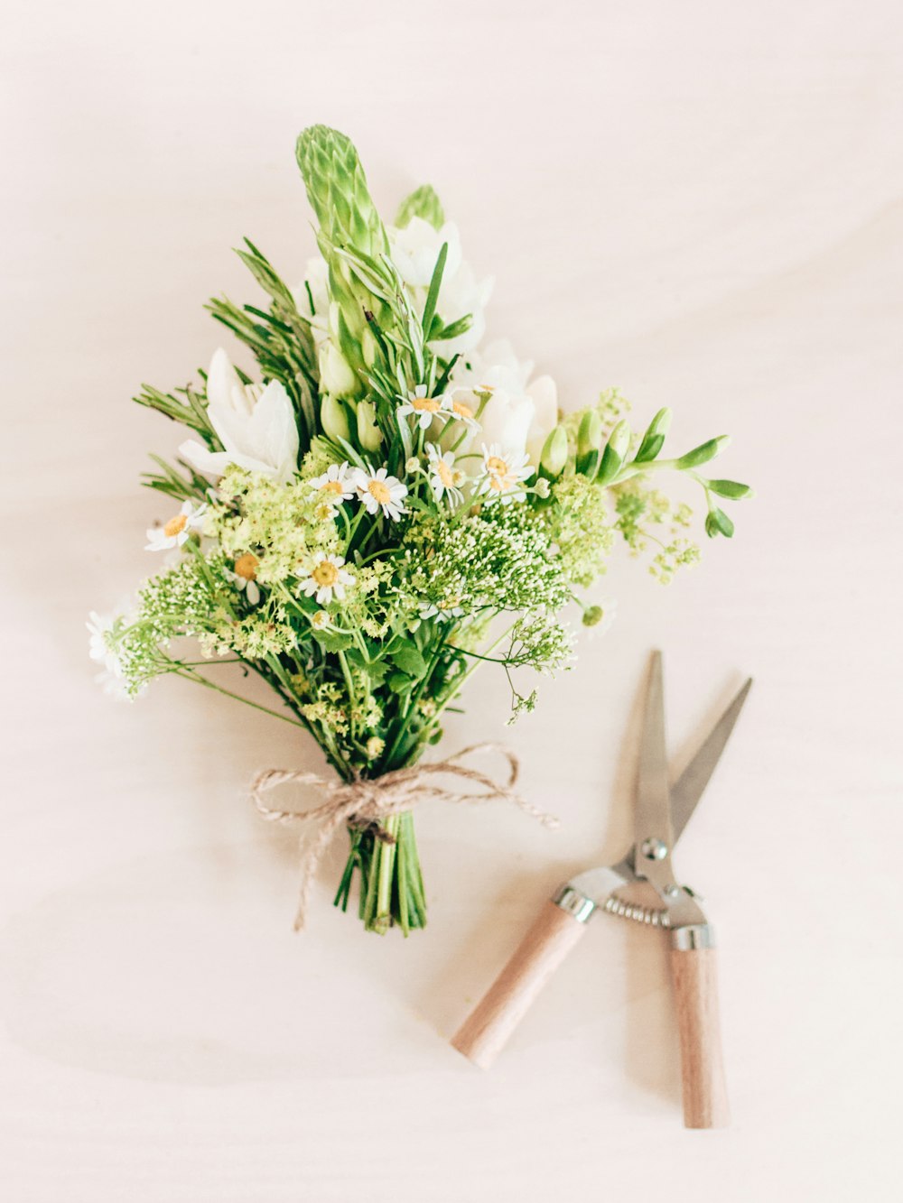 a bouquet of flowers and a pair of scissors
