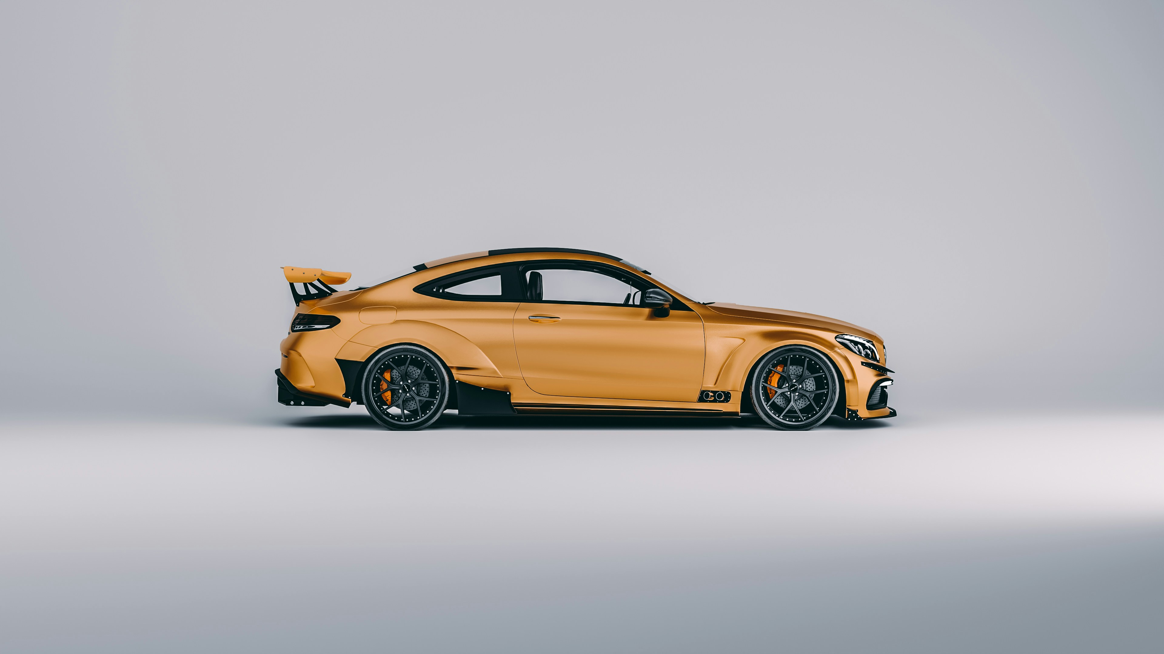Orange sports car parked in a studio