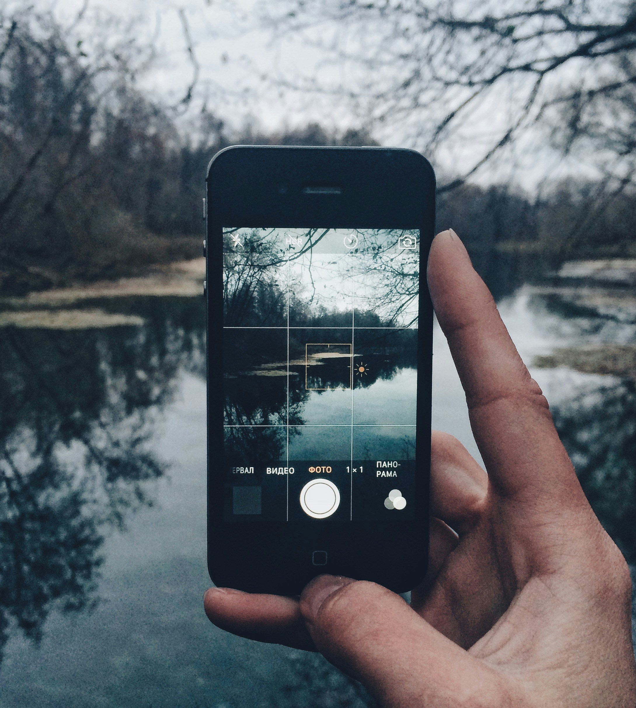 a person holding a cell phone in their hand