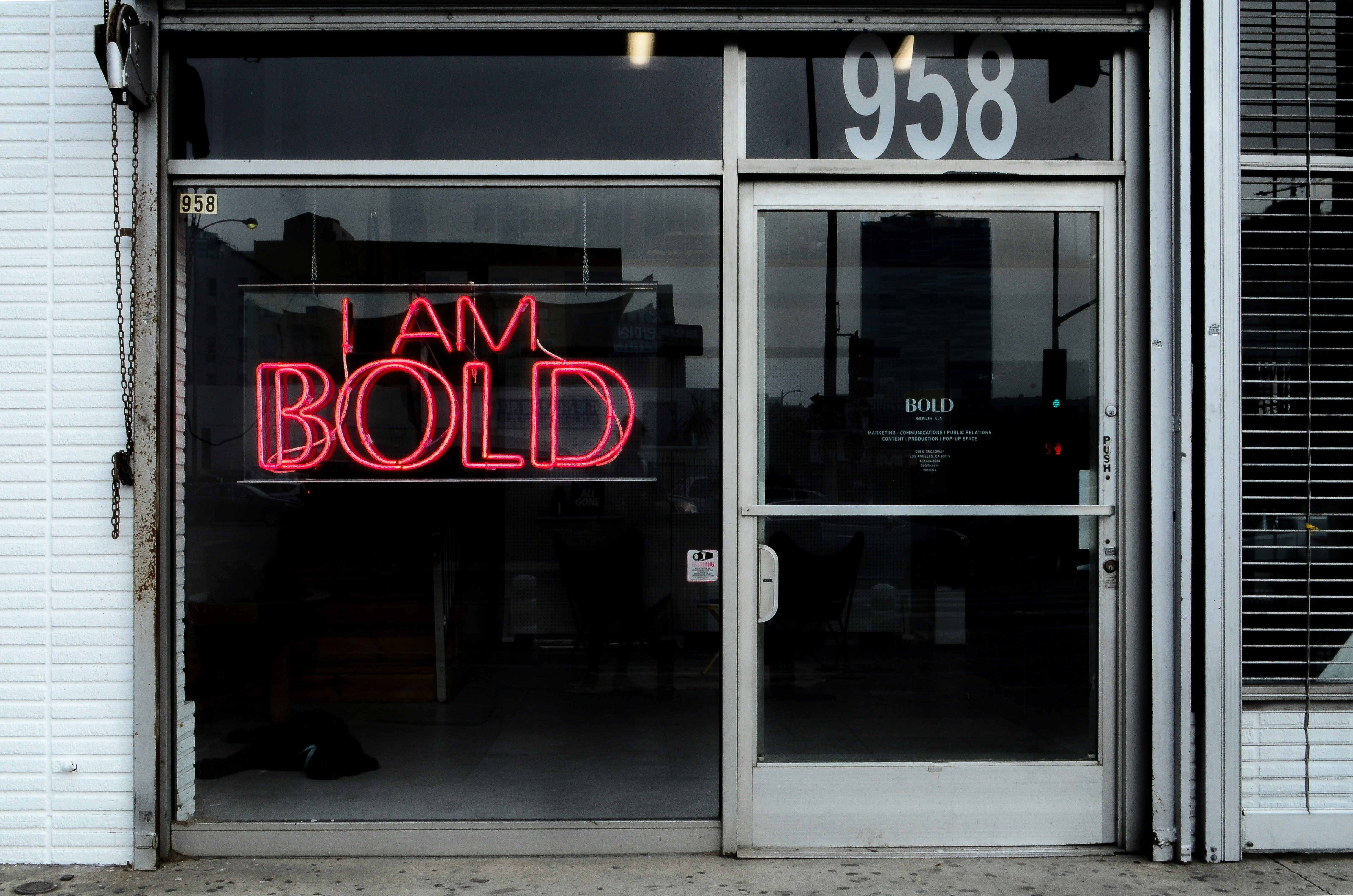 a red neon sign that reads i am bold
