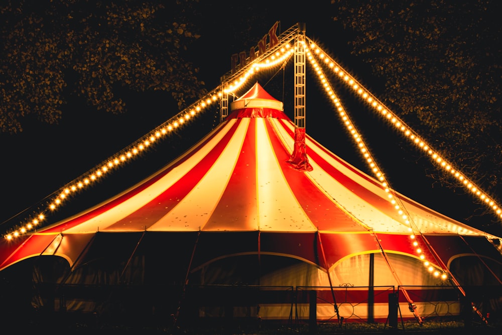 a large circus tent with lights around it
