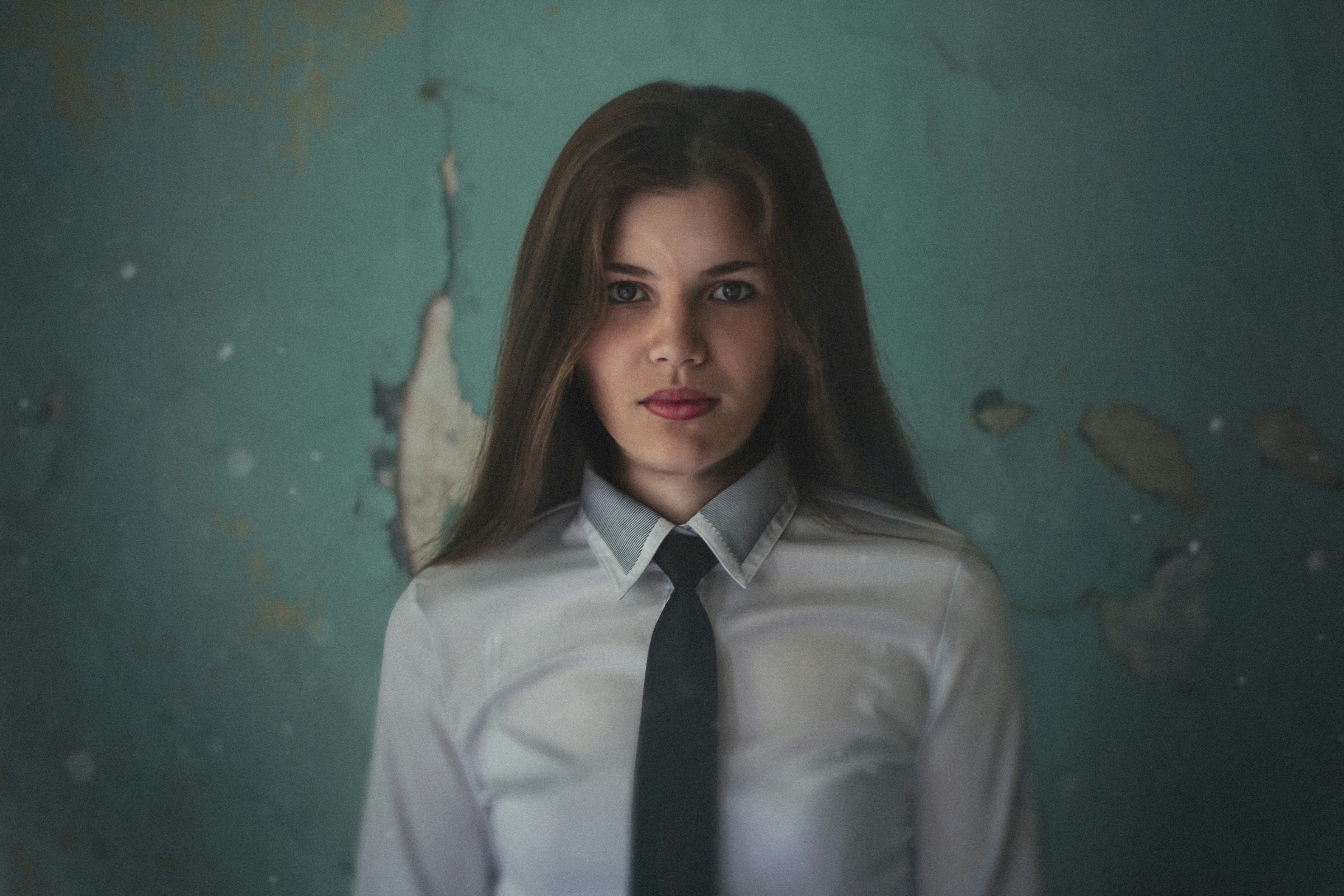 a woman in a white shirt and black tie