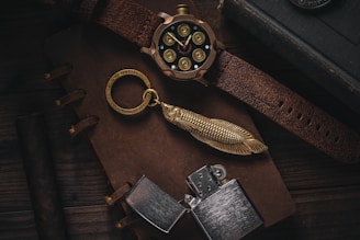 a watch and a keychain sitting on a table